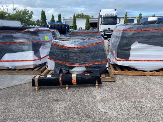 Pallets filled with black and white bags — Daily Express Couriers in Bowen, QLD